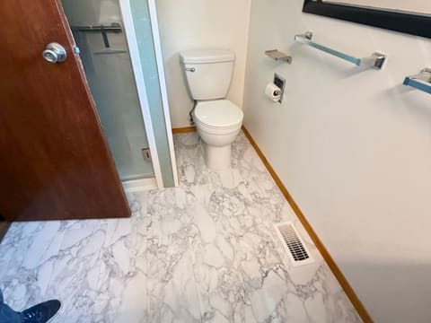 Bathroom with newly laid marble-look tile floor