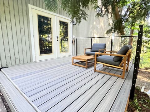 Finished deck with cable railing under trees